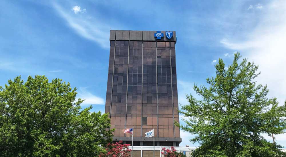 building with blue sky and trees