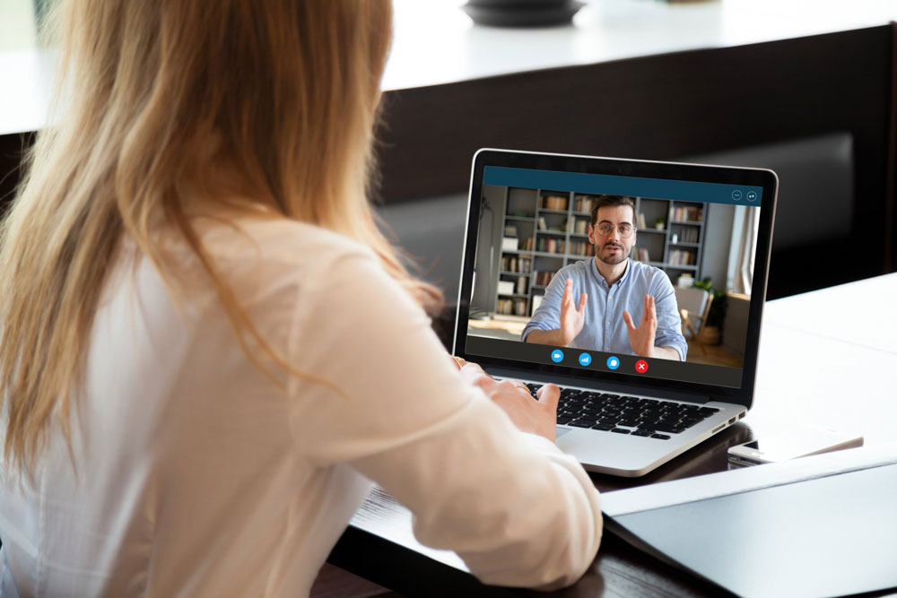 Doctor talks with patient on computer