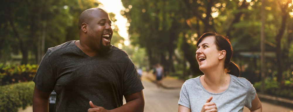 man and woman running in park 