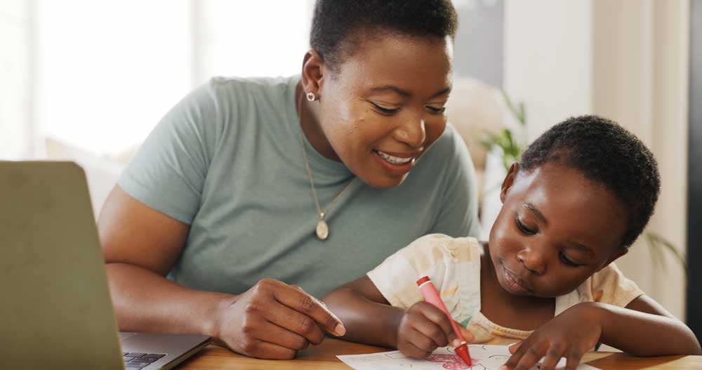 woman with child with laptop open